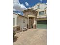Charming front entrance featuring stone accents, a bistro set, and a secure three-quarters glass front door at 1350 E Racine Dr, Casa Grande, AZ 85122