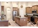 Beautiful kitchen featuring an island, stainless steel appliances and lots of storage at 1421 W Rylie Ct, Queen Creek, AZ 85144
