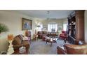 Cozy living room with built-in bookcase, plush seating, and neutral decor at 16112 W Whitton Ave, Goodyear, AZ 85395