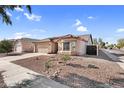 Inviting home exterior with desert landscaping, a two-car garage, and a charming, covered front entry at 17152 W Watkins St, Goodyear, AZ 85338