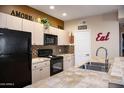 Functional kitchen featuring black appliances, light cabinets, and neutral countertops with decorative accents at 18416 N Cave Creek Rd # 3050, Phoenix, AZ 85032