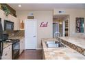 Well-equipped kitchen showcases tile countertops and backsplash, complementing the black appliances at 18416 N Cave Creek Rd # 3050, Phoenix, AZ 85032
