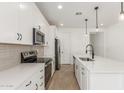 Well-equipped kitchen showcases stainless appliances, an island, and stylish hardware at 18498 E Dario Rd, Gold Canyon, AZ 85118