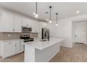 Bright kitchen features an island, stainless appliances, and modern pendant lights at 18498 E Dario Rd, Gold Canyon, AZ 85118