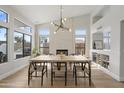 The dining room has vaulted ceilings, lots of natural light, a fireplace, and a view of the backyard at 19203 N 39Th Way, Phoenix, AZ 85050