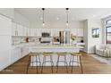 Modern, bright kitchen with white cabinets, a quartz countertop island, and stainless steel appliances at 19203 N 39Th Way, Phoenix, AZ 85050