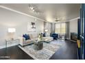 Elegant living room featuring dark wood floors, modern decor, and a plush sectional sofa at 19777 N 76Th St # 3229, Scottsdale, AZ 85255