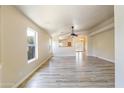 Bright and airy living room featuring modern wood-look tile floors and neutral paint at 206 N 152Nd Ave, Goodyear, AZ 85338