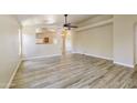 Spacious living room with light wood-look tile flooring and abundant natural light at 206 N 152Nd Ave, Goodyear, AZ 85338