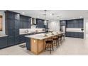 This expansive kitchen includes a large island and modern appliances at 21341 S 227Th Way, Queen Creek, AZ 85142