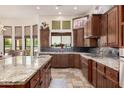 Beautiful kitchen boasting custom wood cabinetry, granite countertops, and stainless steel appliances at 21615 E Pegasus Pkwy, Queen Creek, AZ 85142