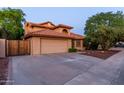Charming two-story home with a terracotta roof, well-maintained yard and a large attached two-car garage at 2239 S Cottonwood --, Mesa, AZ 85202