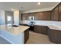 Well-equipped kitchen features an island, stainless steel appliances, and ample cabinetry for storage at 23328 W Miami St, Buckeye, AZ 85326