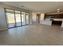Open-concept living room with tile flooring, seamlessly connecting indoor and outdoor spaces through sliding glass doors at 23328 W Miami St, Buckeye, AZ 85326