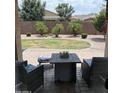 Paver patio with a firepit overlooking the lawn with stone groundcover and palm trees at 2665 E Gillcrest Rd, Gilbert, AZ 85298