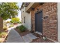 Inviting front entrance with stone accents, a welcome mat, and desert landscaping at 2727 N Price Rd # 3, Chandler, AZ 85224