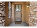 Close up of the front door surrounded by stone detail at 28990 N White Feather Ln # 121, Scottsdale, AZ 85262
