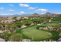 Picturesque golf course view showcasing players and the scenic desert landscape with stunning mountain backdrop at 28990 N White Feather Ln # 121, Scottsdale, AZ 85262