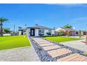 Charming home featuring a lush green lawn, decorative pathway, and fresh exterior paint at 2926 N 16Th Ave, Phoenix, AZ 85015