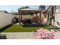 Relaxing backyard featuring a gazebo, artificial grass, and patio at 3017 E Bluefield Ave, Phoenix, AZ 85032