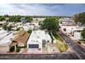 Home showcasing desert landscaping, attached garage, and mature trees from above at 3029 W Sierra St, Phoenix, AZ 85029