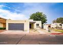 Inviting home with xeriscape front yard, gray garage door, and covered entryway at 3029 W Sierra St, Phoenix, AZ 85029