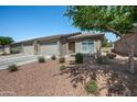 Attractive single-story home with three-car garage, desert landscaping, and seating on the front porch at 3117 S Signal Butte Rd # 484, Mesa, AZ 85212