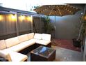 Back patio showing a white sectional couch with an umbrella and table at 3650 E Montecito Ave # 4, Phoenix, AZ 85018