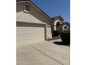 A view of the home's attached garage and landscaped front yard at 3700 E Sandwick Dr, San Tan Valley, AZ 85140