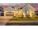 Charming modern farmhouse featuring a well-maintained lawn and lovely landscaping, illuminated by warm exterior lighting at 4007 N 34Th St, Phoenix, AZ 85018