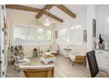 Cozy living area featuring wood-look floors, plantation shutters, exposed wood beams, and inviting neutral decor at 4450 S Frequency --, Mesa, AZ 85212