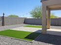 Low-maintenance backyard boasts artificial turf, pavers, gravel, a block wall, and a covered patio at 48171 N La Soledad --, Gold Canyon, AZ 85118