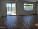 Spacious living room with wood-look tile flooring and sliding glass doors leading to the backyard at 48171 N La Soledad --, Gold Canyon, AZ 85118