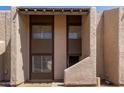 Two-story townhome with a stucco facade, contrasting brown trim, and a neatly kept walkway to the front door at 5742 N 43Rd Dr, Glendale, AZ 85301
