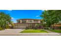 Beautiful home with a three-car garage, stone accents, manicured lawn, and a basketball hoop at 643 E Hopkins Rd, Gilbert, AZ 85295