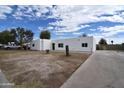 A single-story white home with a long driveway offers ample parking for residents and guests at 6813 W Sherri Jean Ln, Peoria, AZ 85382