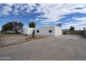 The white exterior of this home is complemented by a long driveway for extra parking at 6813 W Sherri Jean Ln, Peoria, AZ 85382