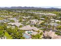 Expansive aerial view showcasing a tennis court, pool, guesthouse, and well-manicured landscaping in this luxury estate at 7272 N 71St St, Paradise Valley, AZ 85253