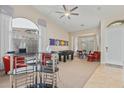 Bright and airy living room with a modern bar, game table and neutral carpet at 7754 E Wolf Canyon St, Mesa, AZ 85207