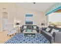 Inviting living room with vaulted ceiling, tile floors, and access to the outdoor space at 7754 E Wolf Canyon St, Mesa, AZ 85207