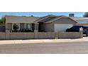 Charming single-story home featuring a low-walled front yard and a two-car garage at 7901 W Tuckey Ln, Glendale, AZ 85303