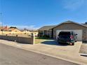 Cozy single-story home boasting a well-maintained lawn and a convenient two-car garage at 7901 W Tuckey Ln, Glendale, AZ 85303