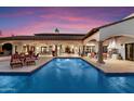 Luxury backyard pool with covered patio, outdoor seating, and elegant architecture at 8515 E Sutton Dr, Scottsdale, AZ 85260