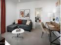 Comfortable living room with modern furnishings and an open floor plan at 8950 W Albeniz Pl, Tolleson, AZ 85353