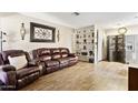 Inviting living room with a large couch, wooden floors, and stylish decor on built-in shelving at 9021 W Elm St # 7, Phoenix, AZ 85037