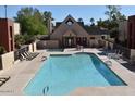 Sparkling community pool with ample lounge chairs and a clubhouse, perfect for relaxing at 1340 N Recker Rd # 224, Mesa, AZ 85205