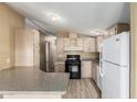 Bright kitchen featuring white appliances, stone countertops and light wooden cabinets at 16246 N 32Nd Way, Phoenix, AZ 85032