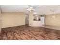 Open concept floor plan with laminate floors connecting living room and kitchen at 16246 N 32Nd Way, Phoenix, AZ 85032