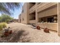 Condominium backyard with gravel, desert landscaping, and a patio area providing an outdoor space at 16307 E Arrow Dr # 104, Fountain Hills, AZ 85268
