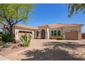 Charming home features a red tile roof, desert landscaping, and a brick driveway at 21623 S 223Rd Pl, Queen Creek, AZ 85142